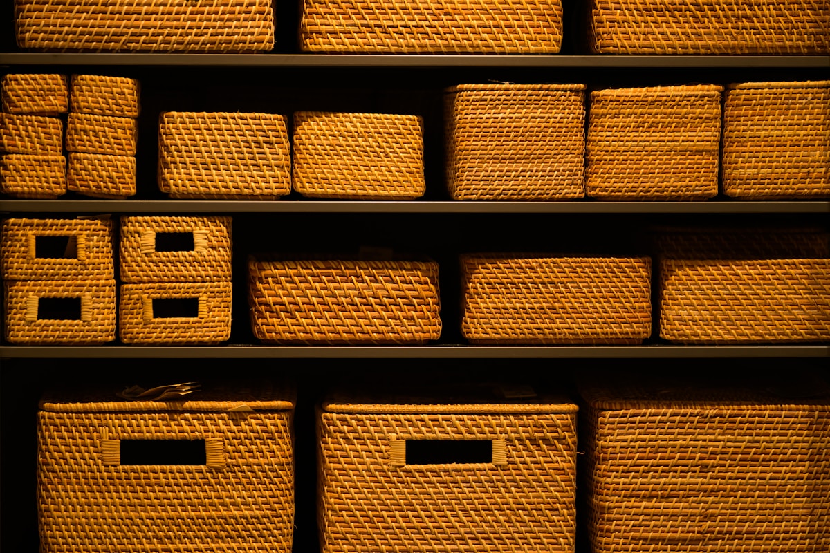 Shelves filled with wicker storage baskets in warm lighting
