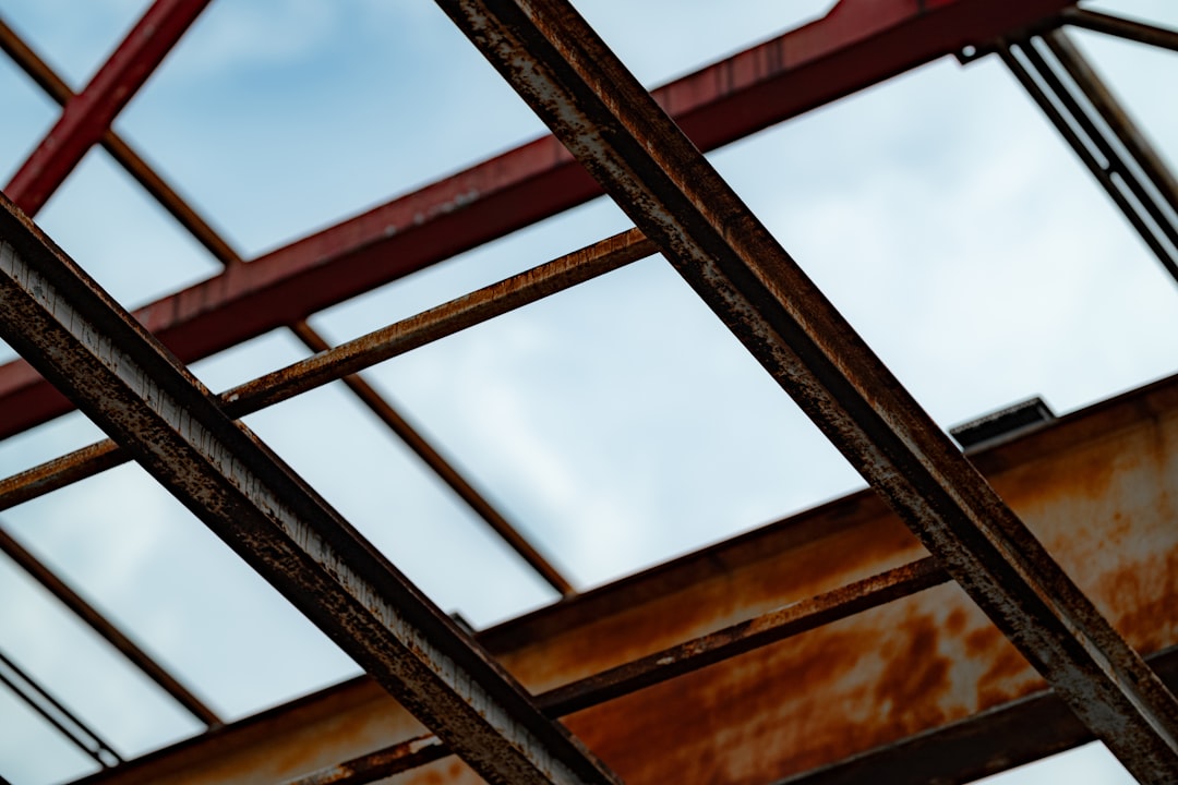A close up of a metal structure with a sky background,