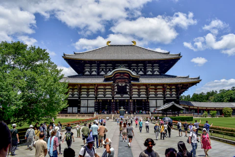 A large group of people standing in front of a building