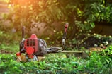 A lawn mower sitting in the middle of a field