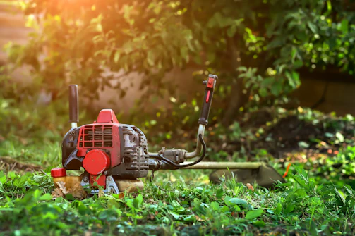 A lawn mower sitting in the middle of a field