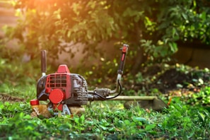A lawn mower sitting in the middle of a field