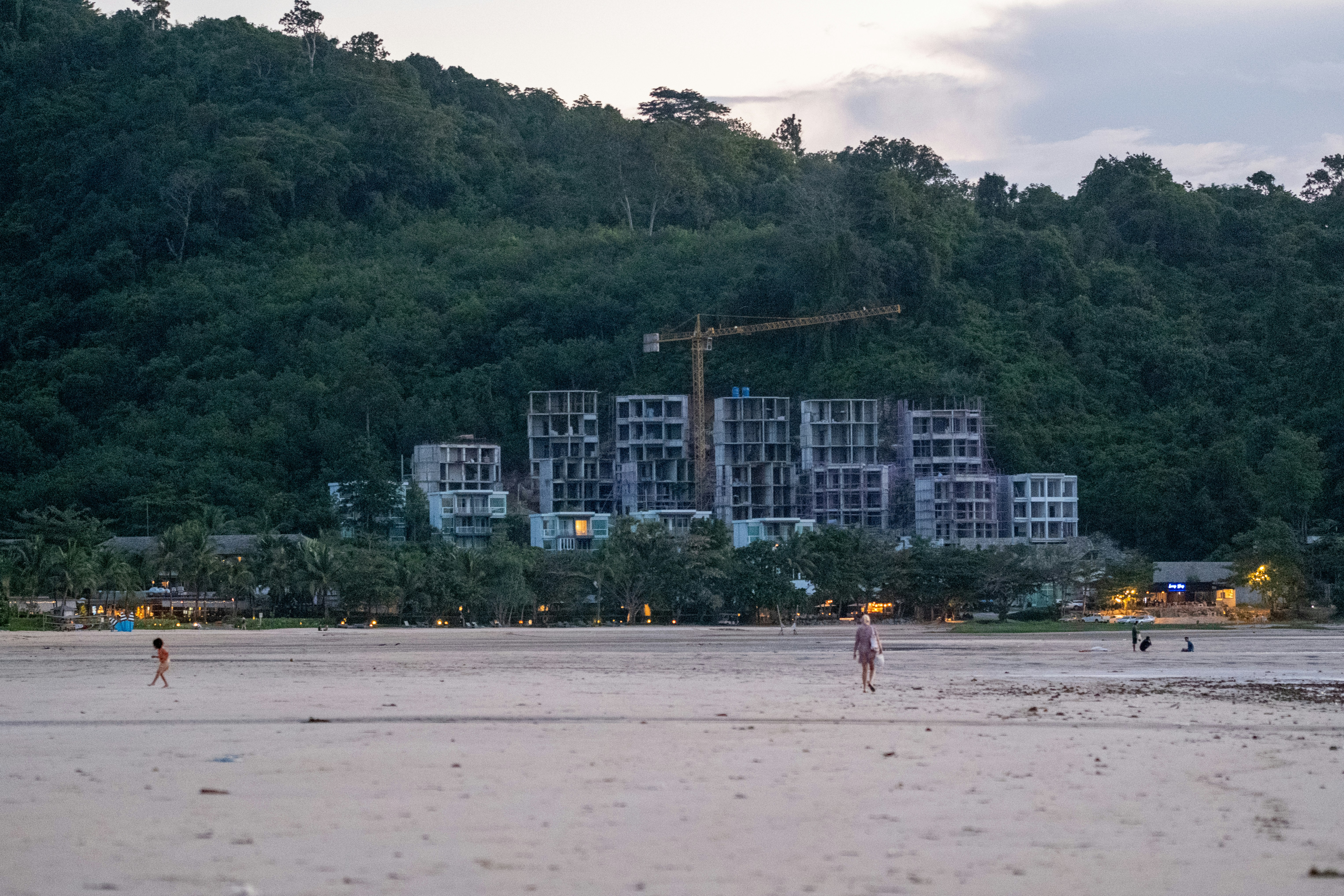 A group of people standing on top of a sandy beach (Photo by Anton Gerasimov on Unsplash)