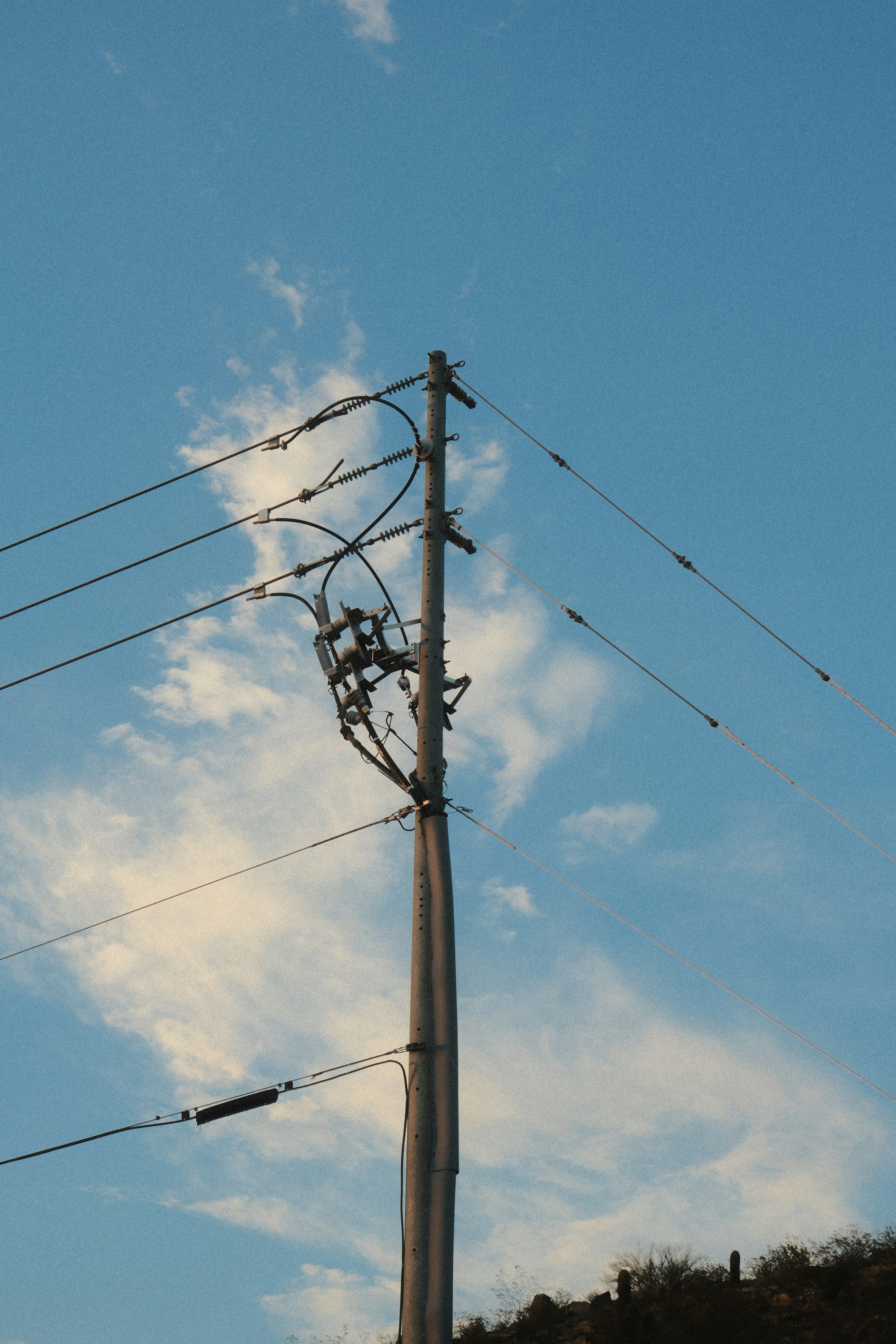 A telephone pole with a sky background