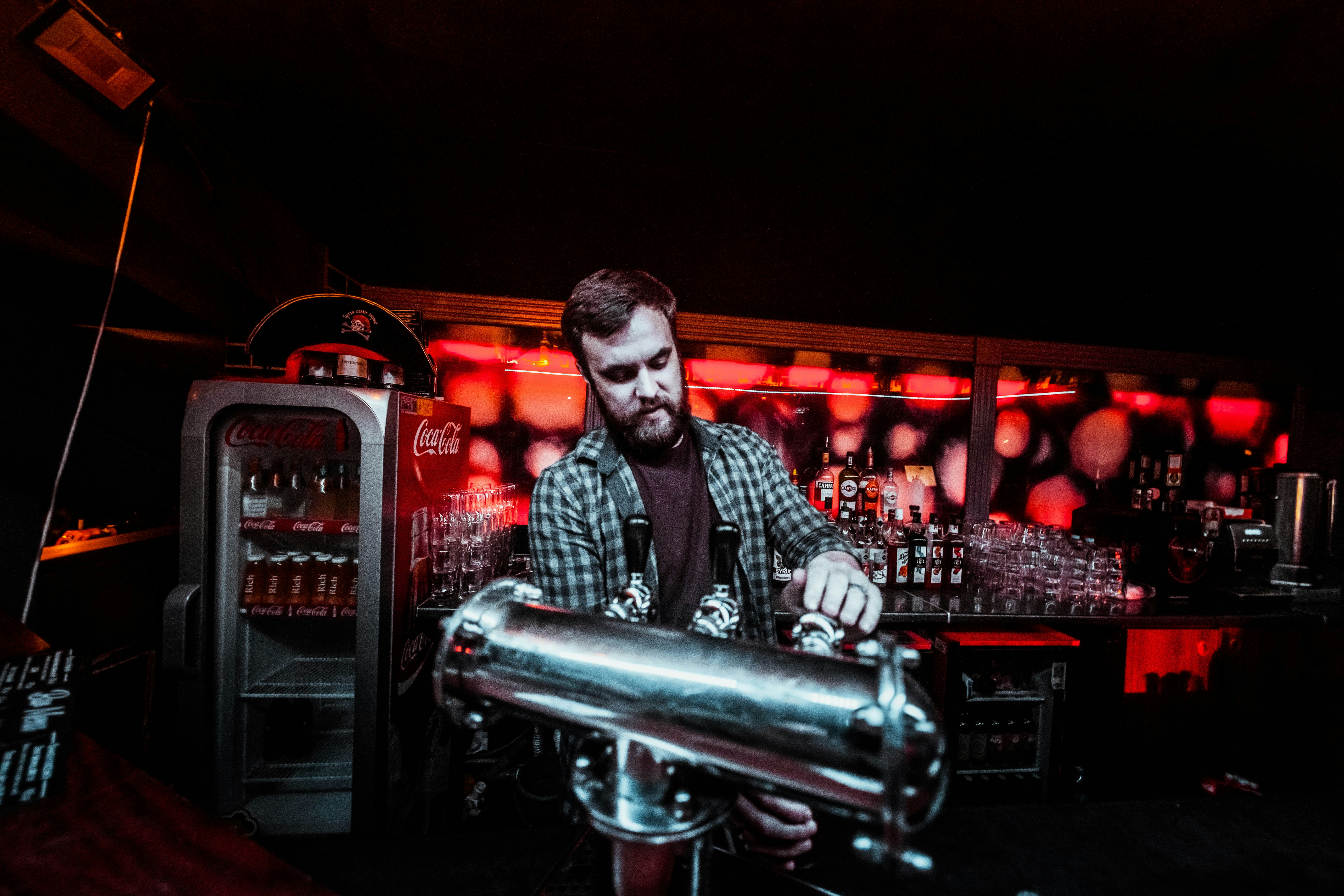 Bartender at a red-lit bar