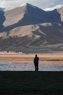 A person standing in front of a body of water