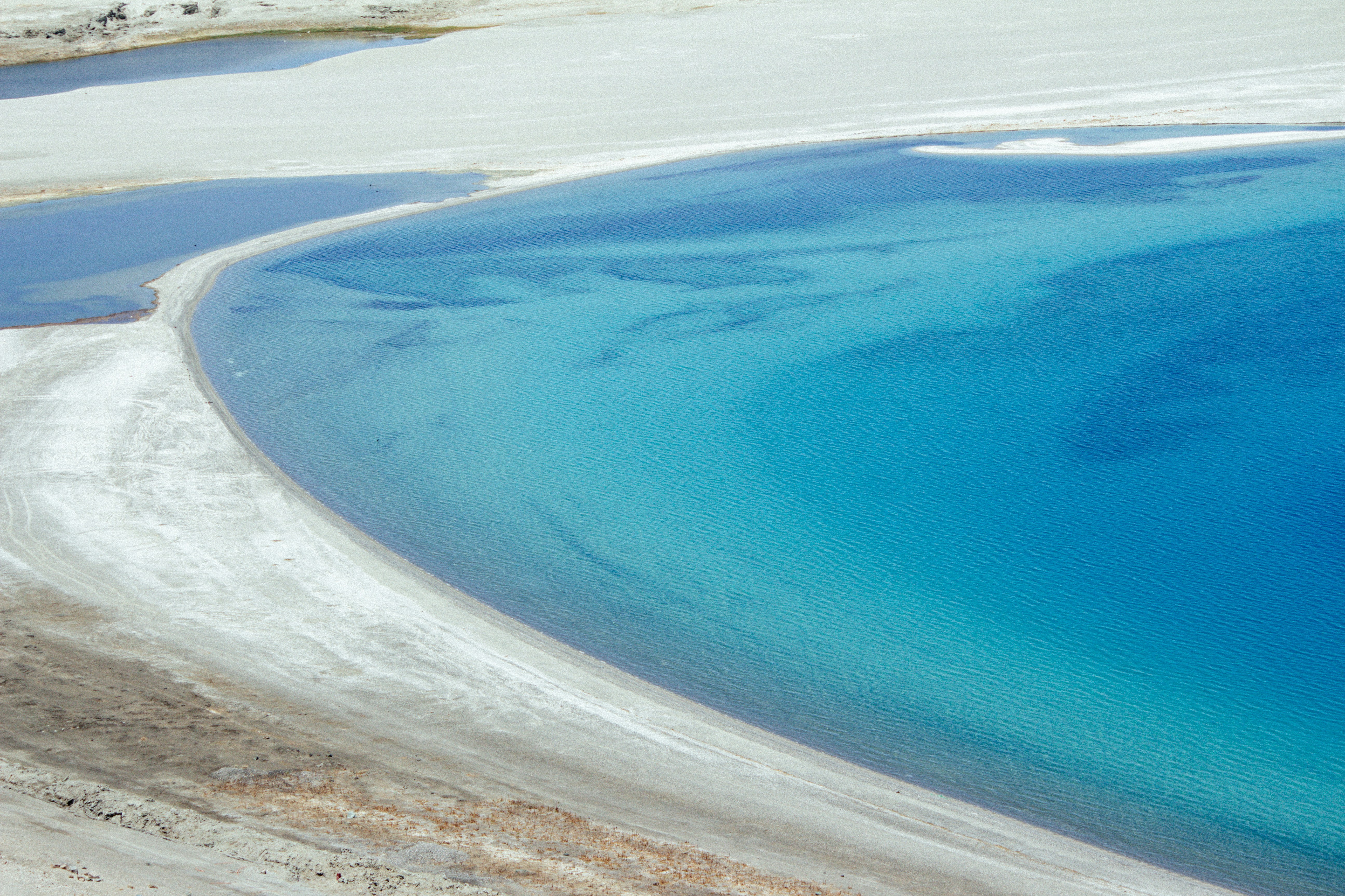A large body of water surrounded by snow