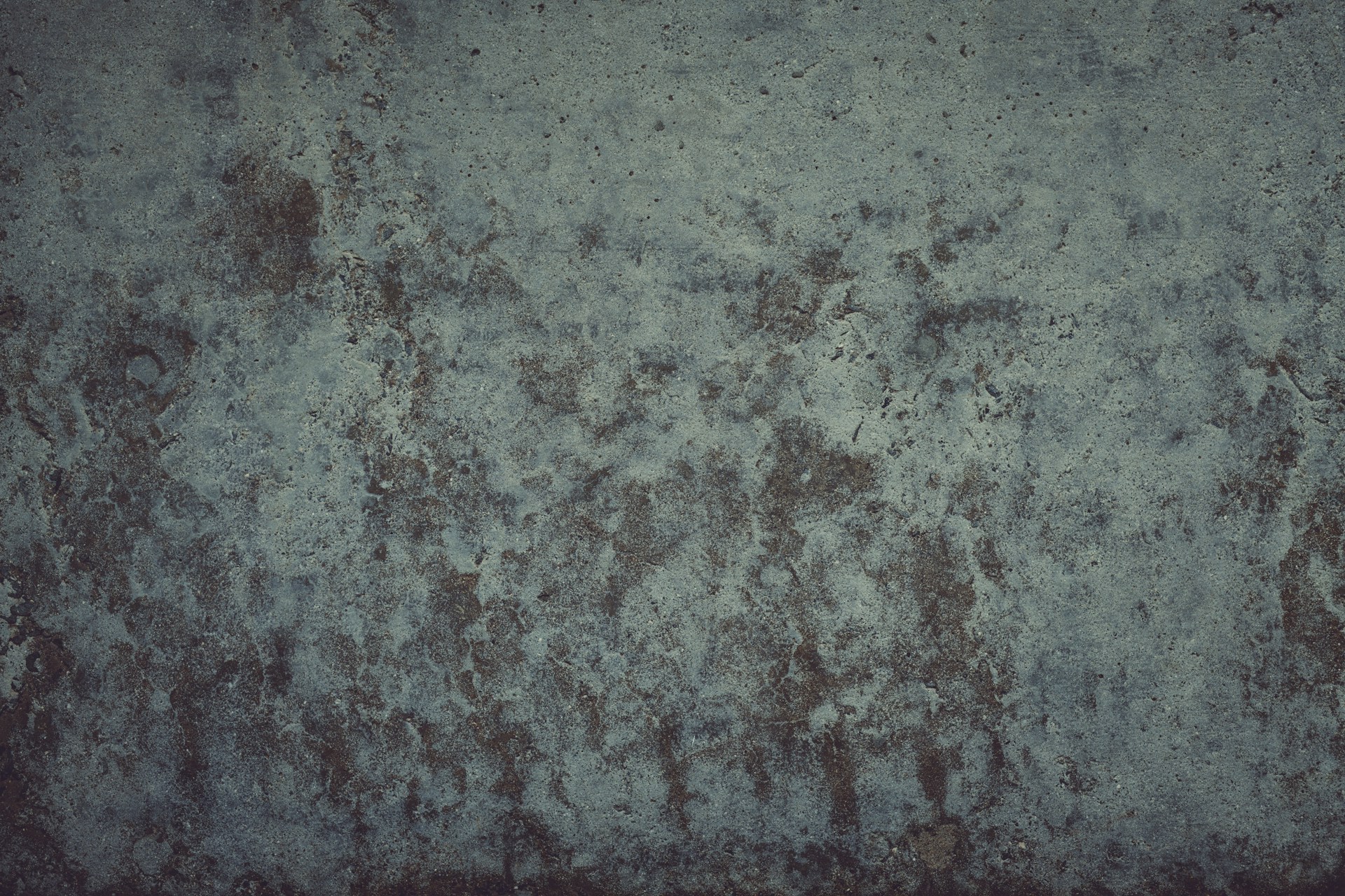 A grungy wall with a red fire hydrant in front of it