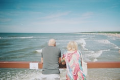 A man and a woman looking out at the ocean