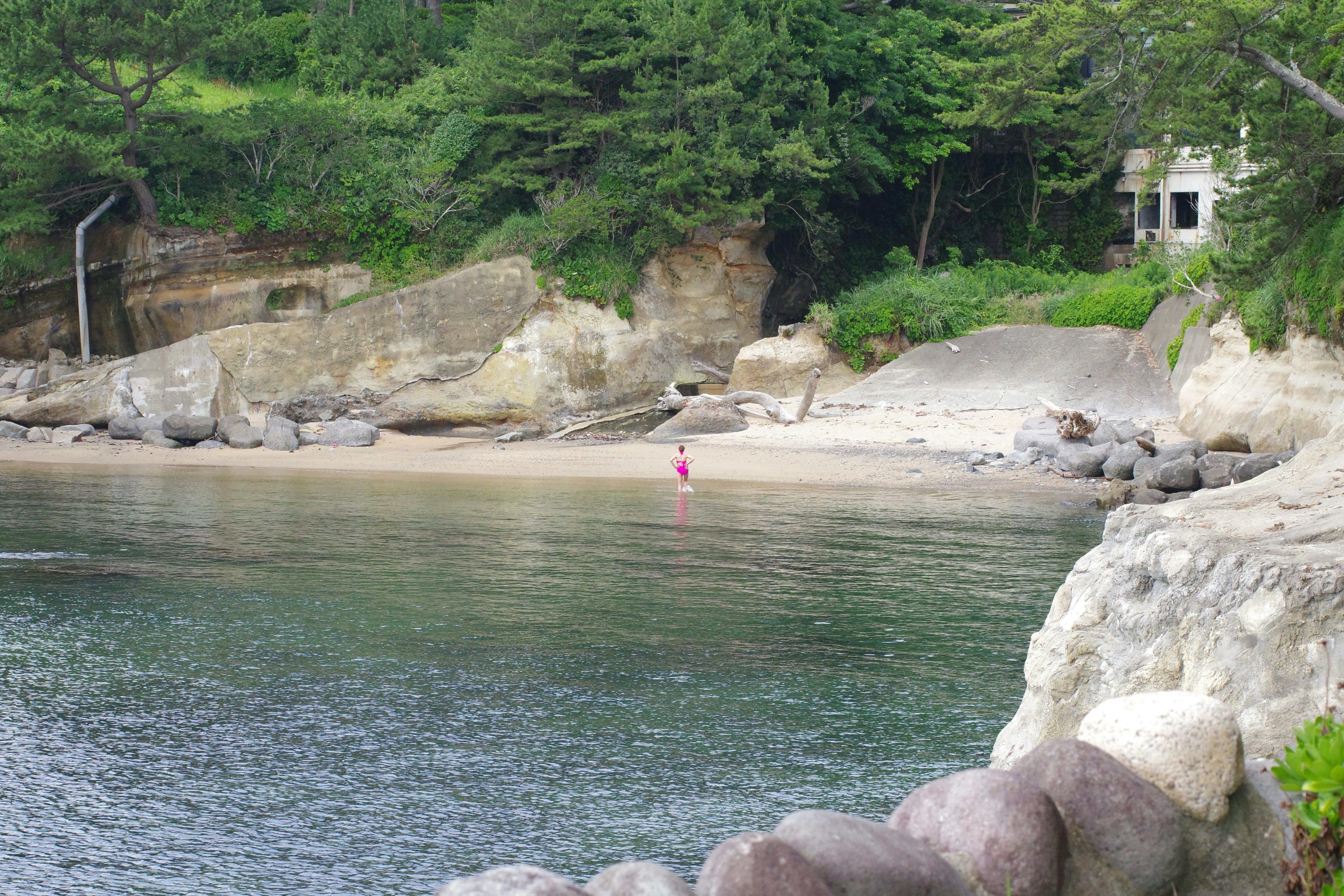 A person is standing on a surfboard in the water
