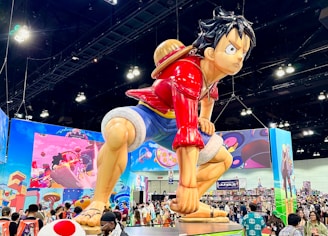 A large statue of a boy kicking a soccer ball
