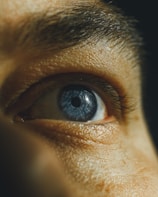 A close up of a man's blue eye