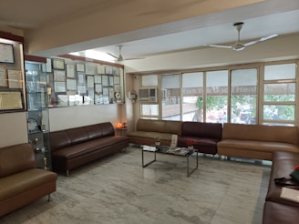 A living room filled with lots of brown furniture
