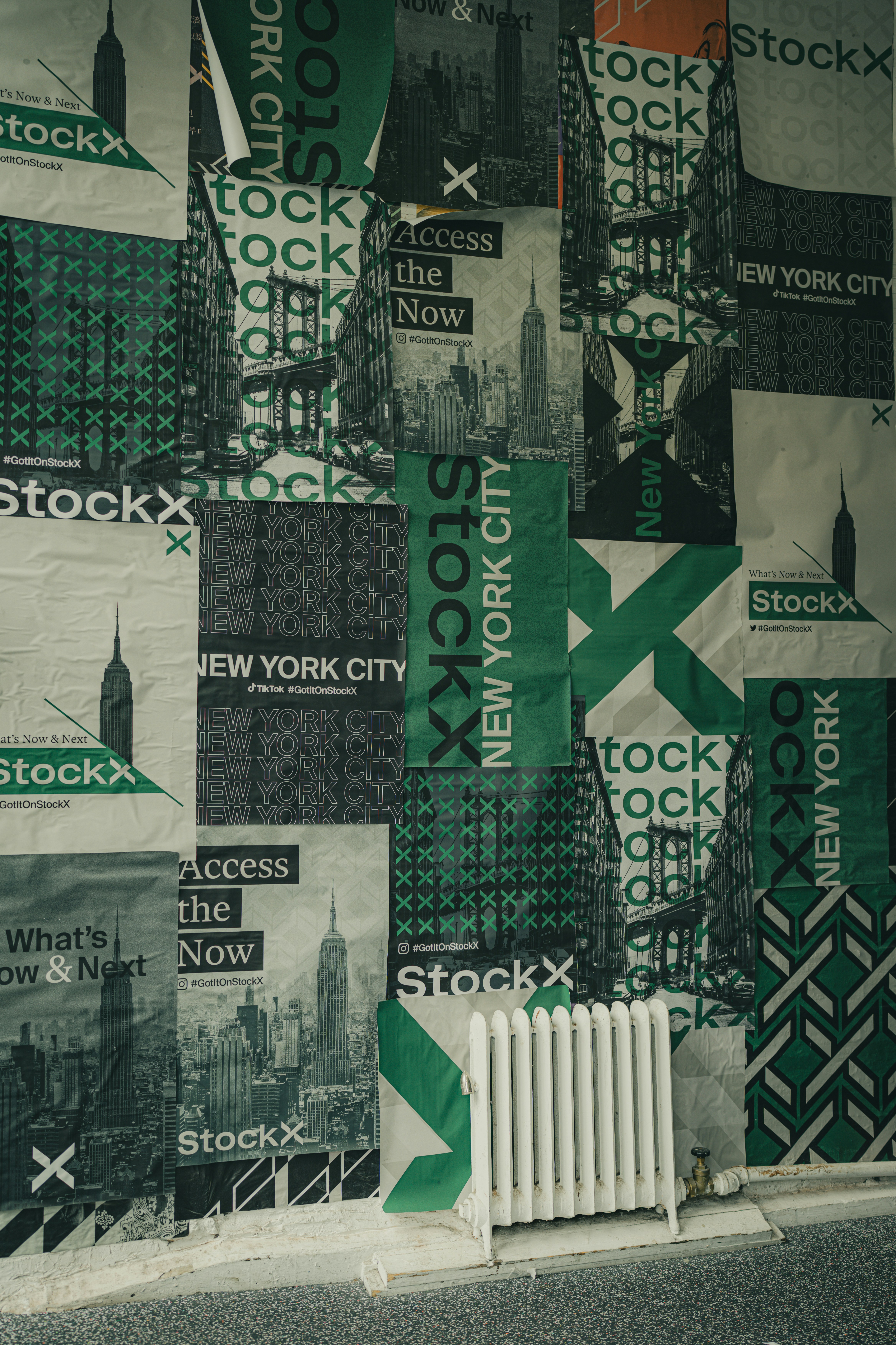 A wall covered in green and white advertisements