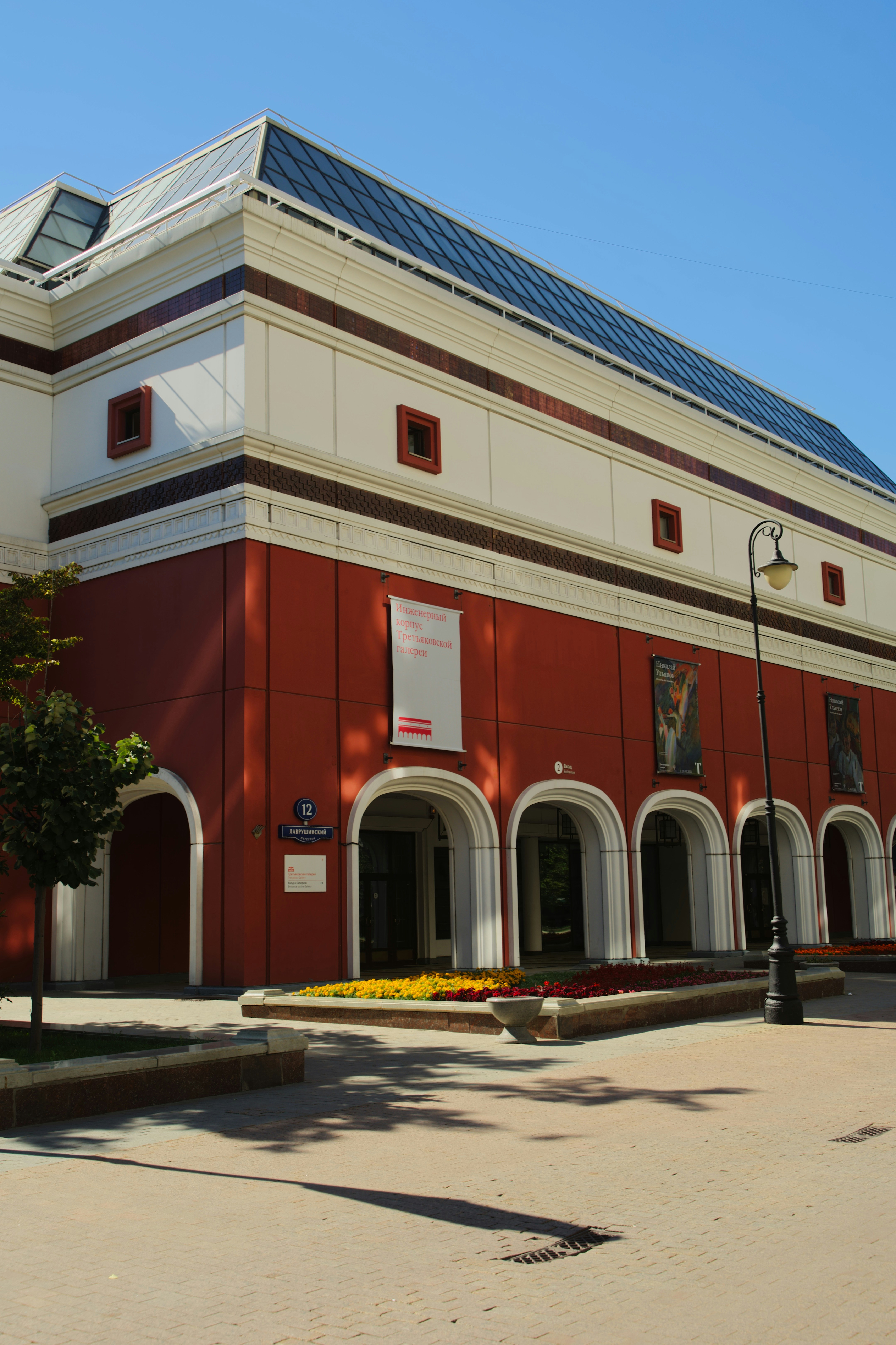 A red building with a solar panel on top of it