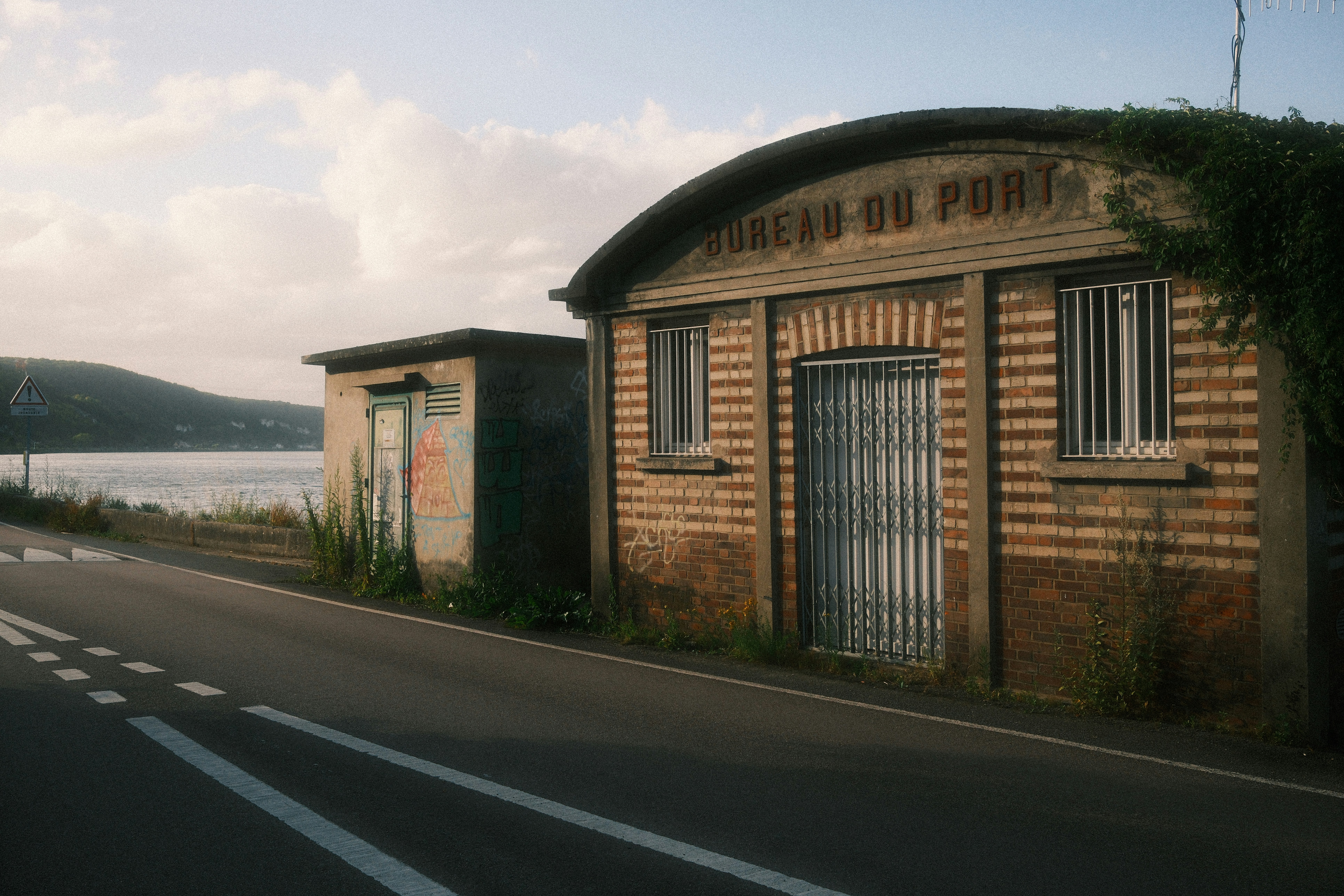 An old building sitting on the side of a road