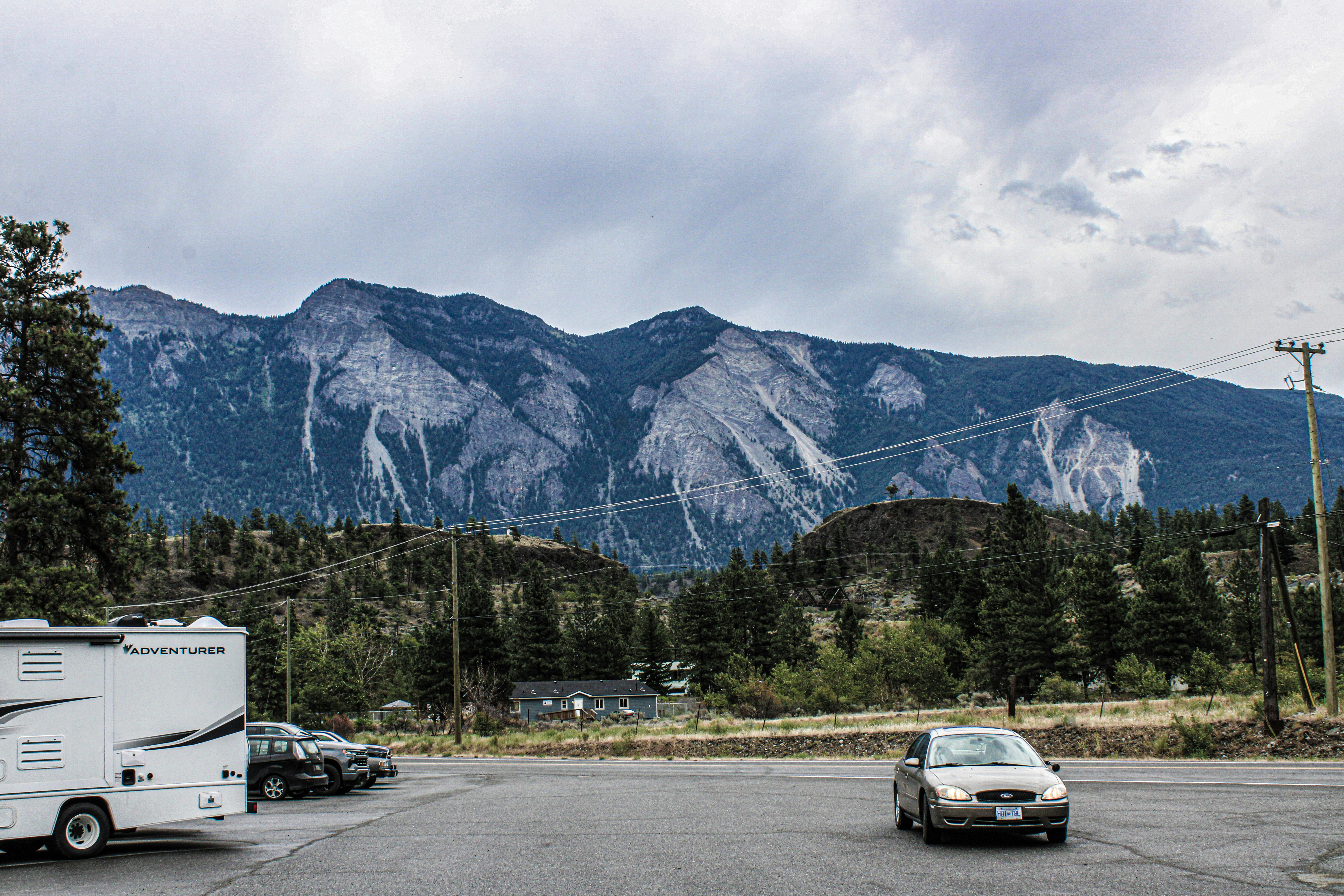 A car parked in a parking lot next to a mountain range