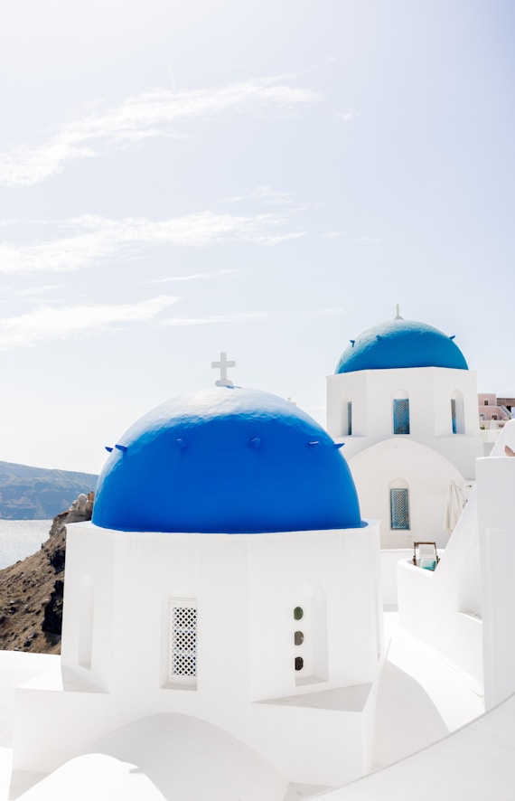 A white and blue building with a cross on top of it