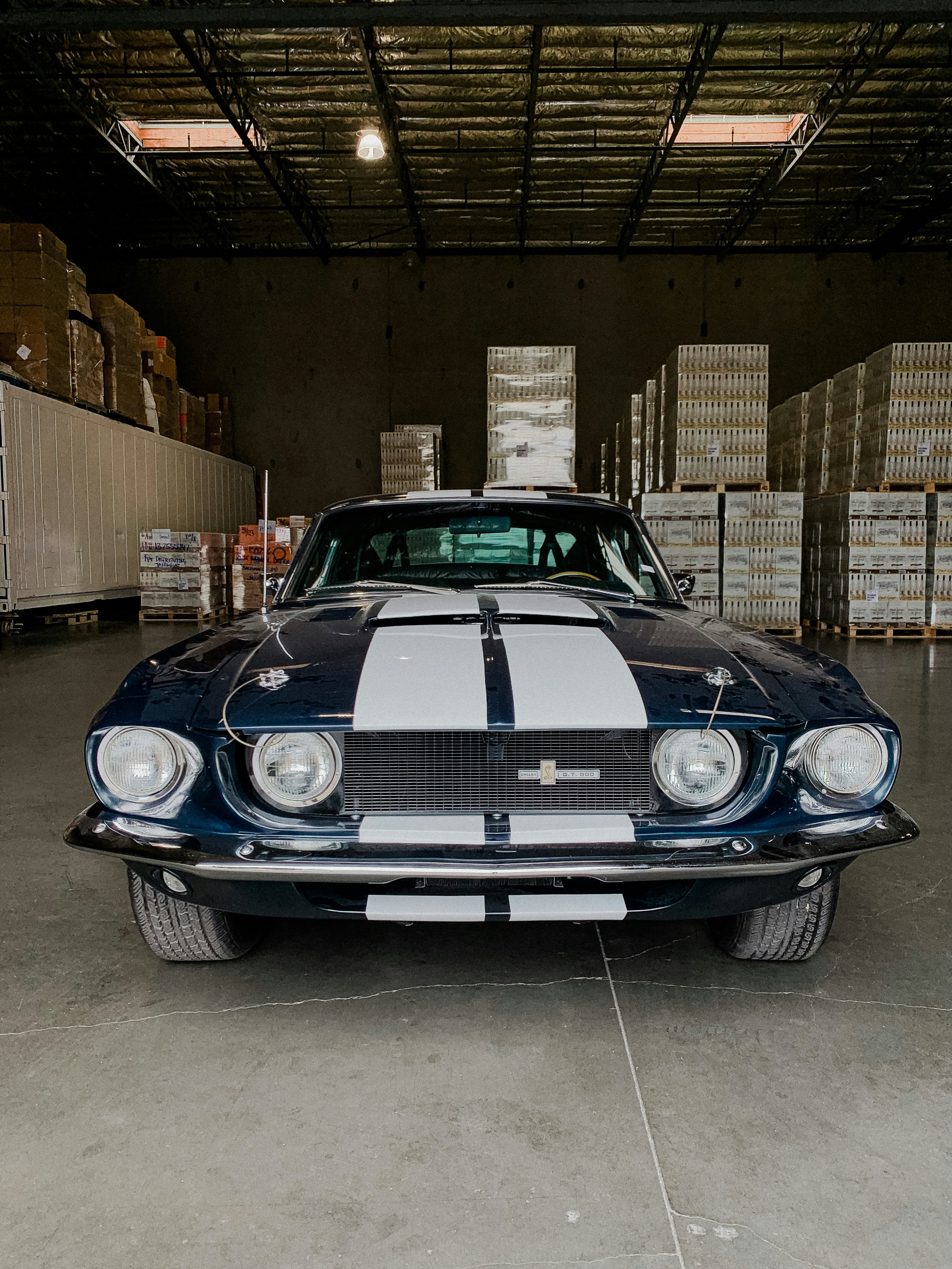 A car parked inside of a garage next to boxes