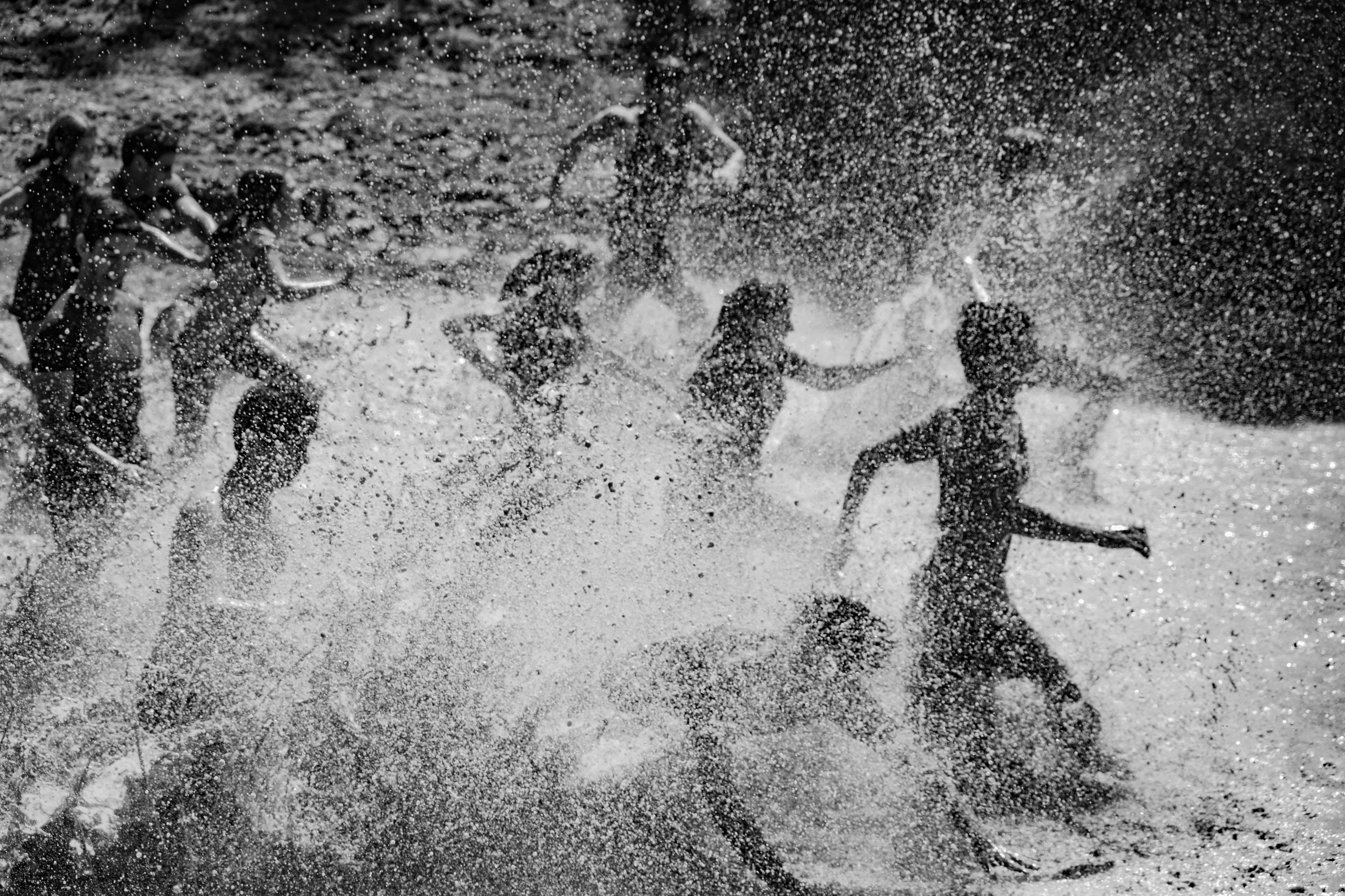 A black and white photo of a group of people surfing
