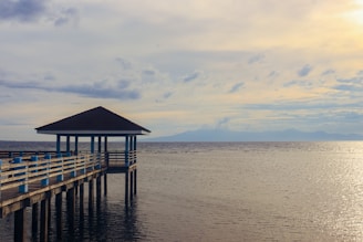 A pier with a gazebo in the middle of the water