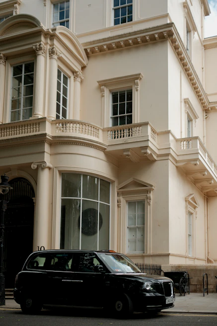 A black car is parked in front of a building