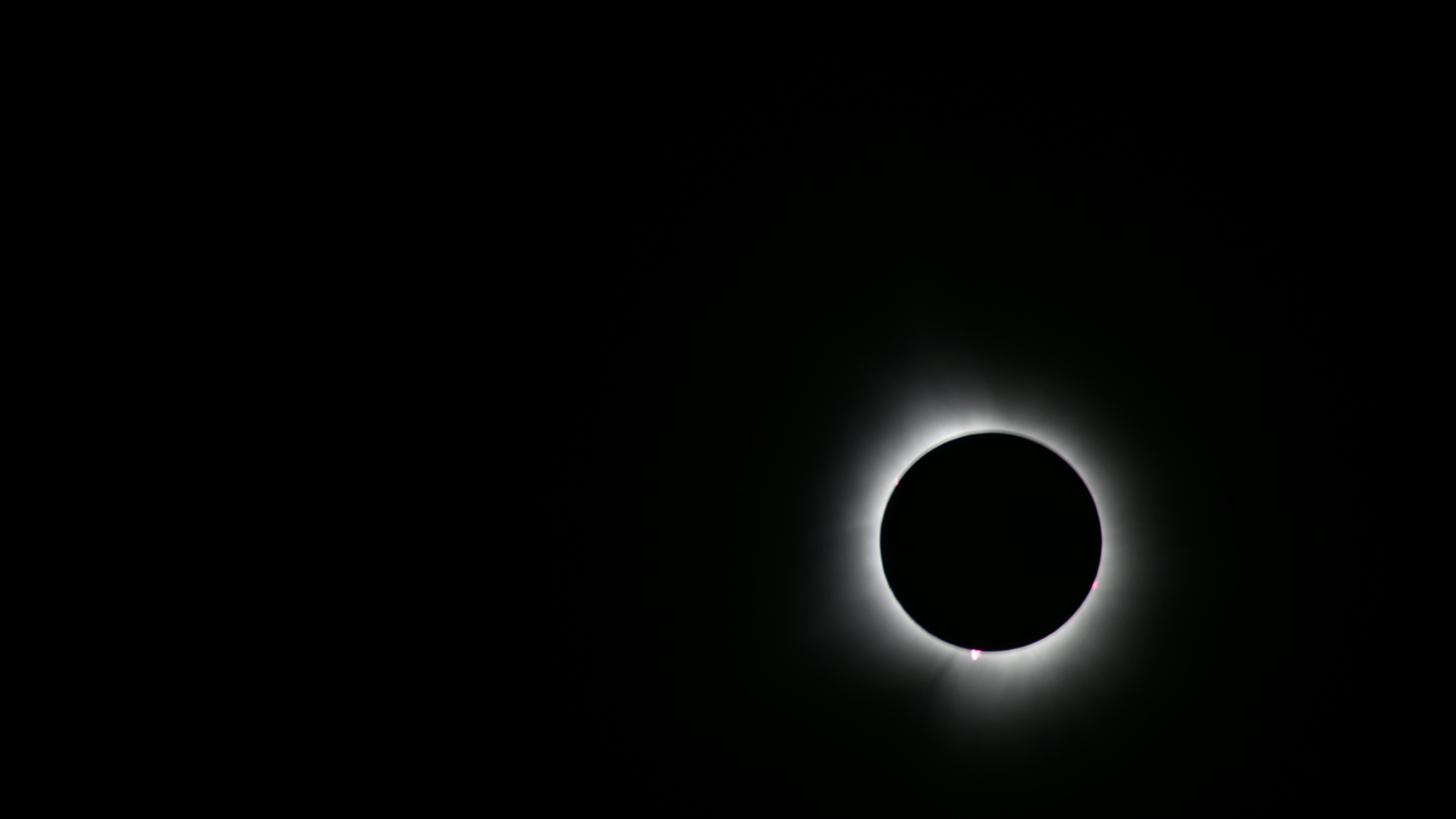 A solar eclipse is seen in the dark sky