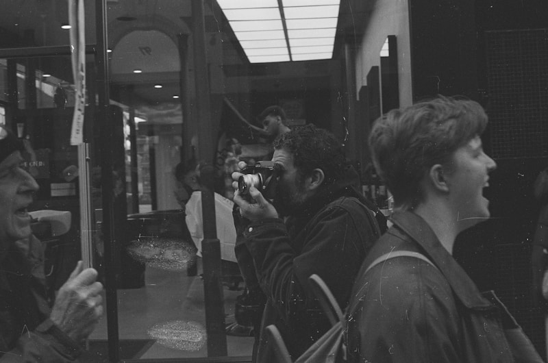 A black and white photo of people on a bus