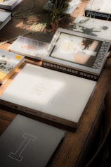 Historical books and documents on a wooden table, preserving family history through AI storytelling.