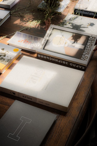 Historical books and documents on a wooden table, preserving family history through AI storytelling.