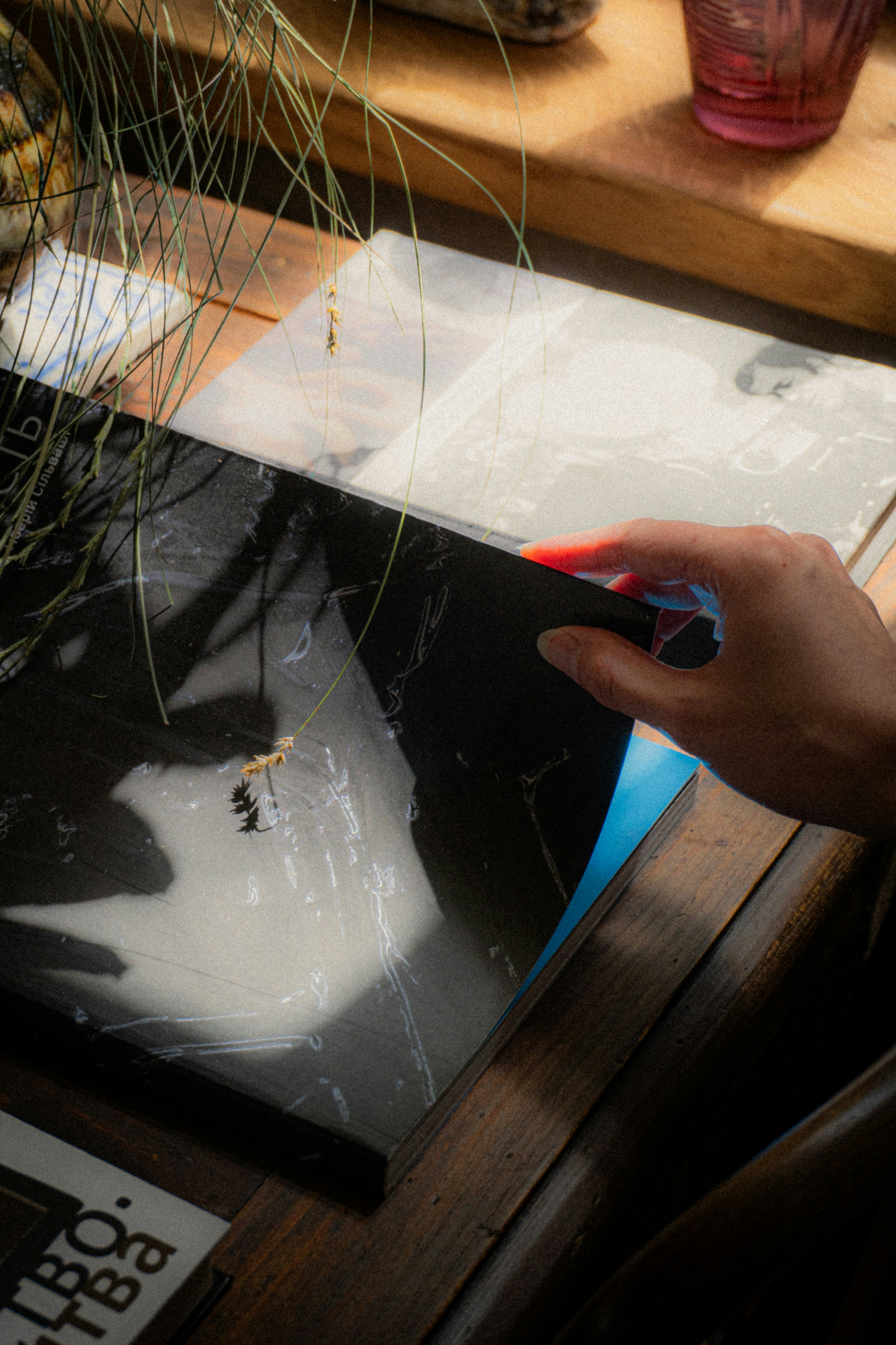 A person using a pair of scissors to cut a piece of paper