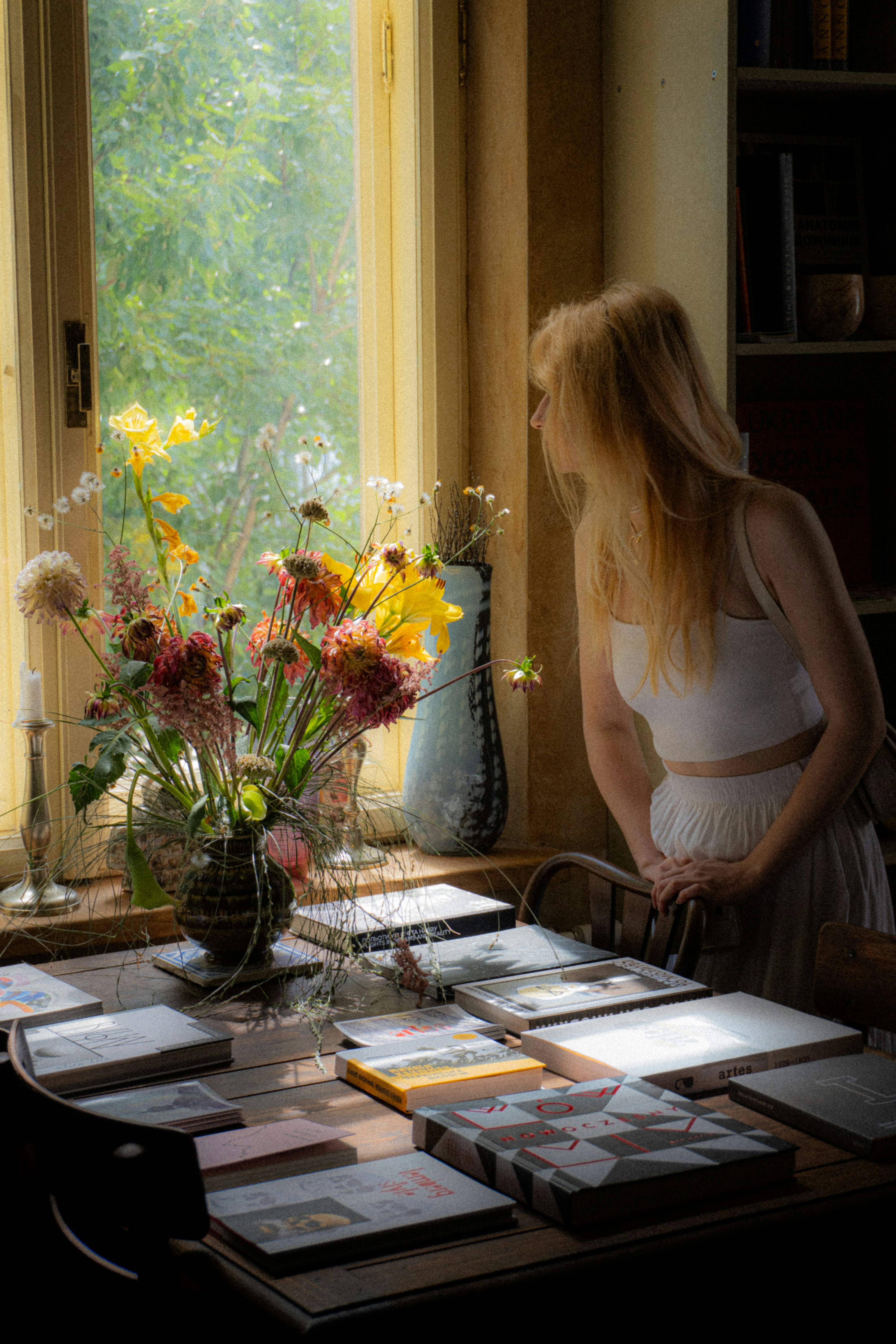 A woman standing in front of a table filled with cards