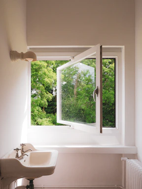 A bathroom with a sink and a window