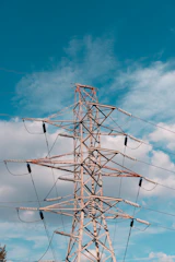 A high voltage power line with a blue sky in the background