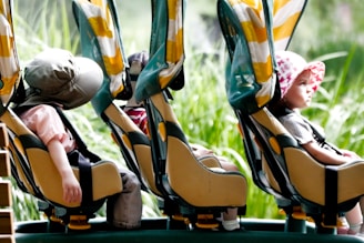 A couple of kids riding on top of a roller coaster