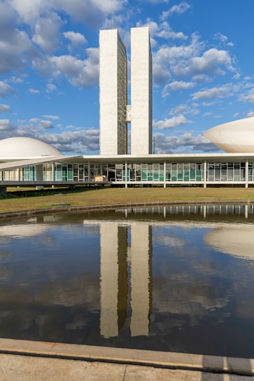 A large building with a large pond in front of it