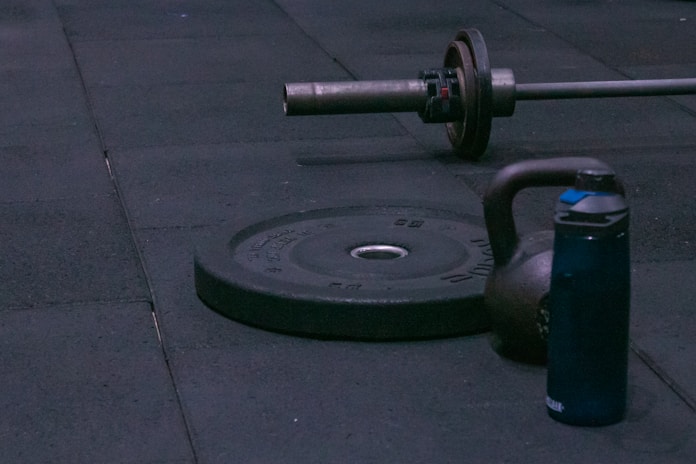 A gym equipment laying on the ground on a sidewalk