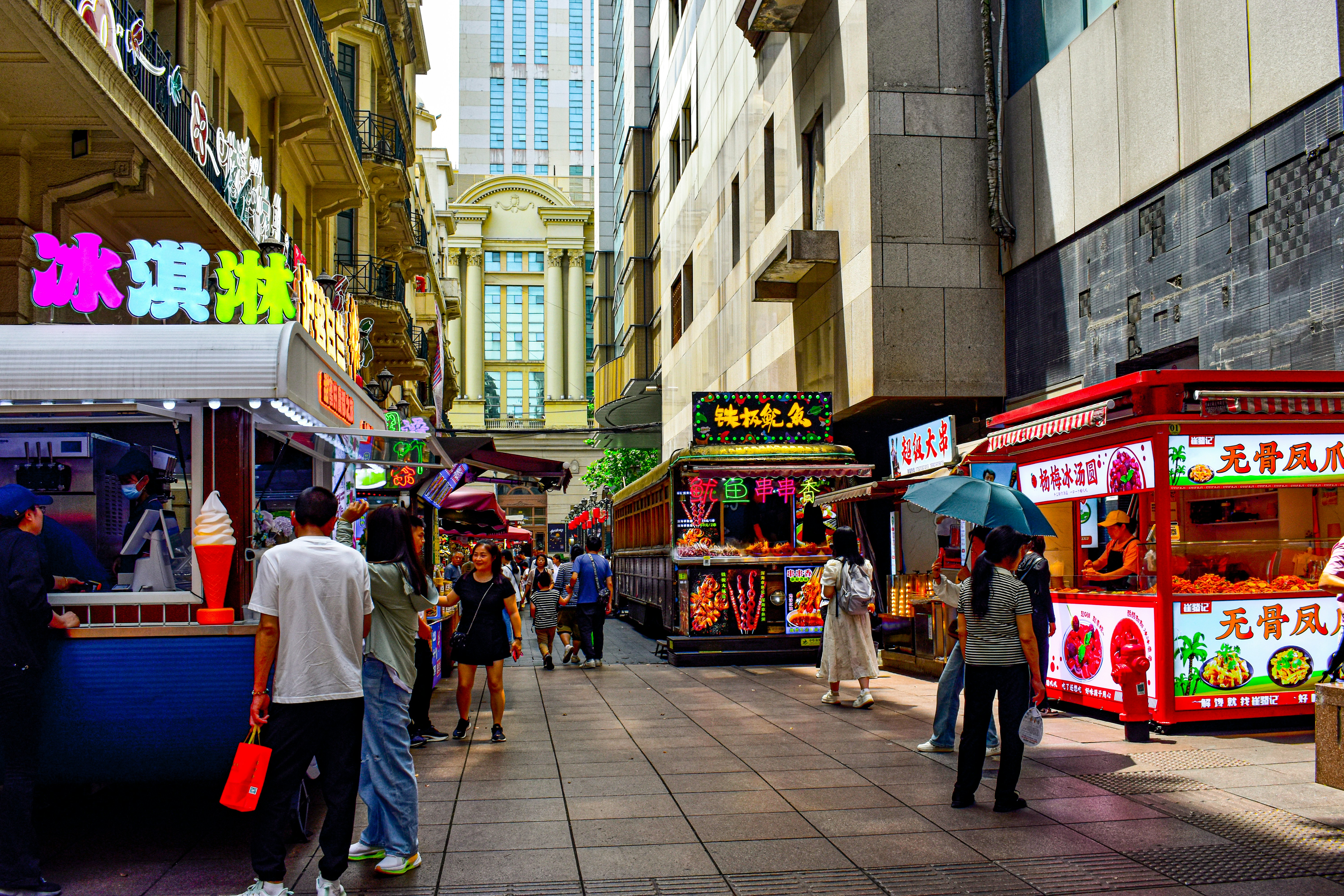 A group of people standing around a food truck