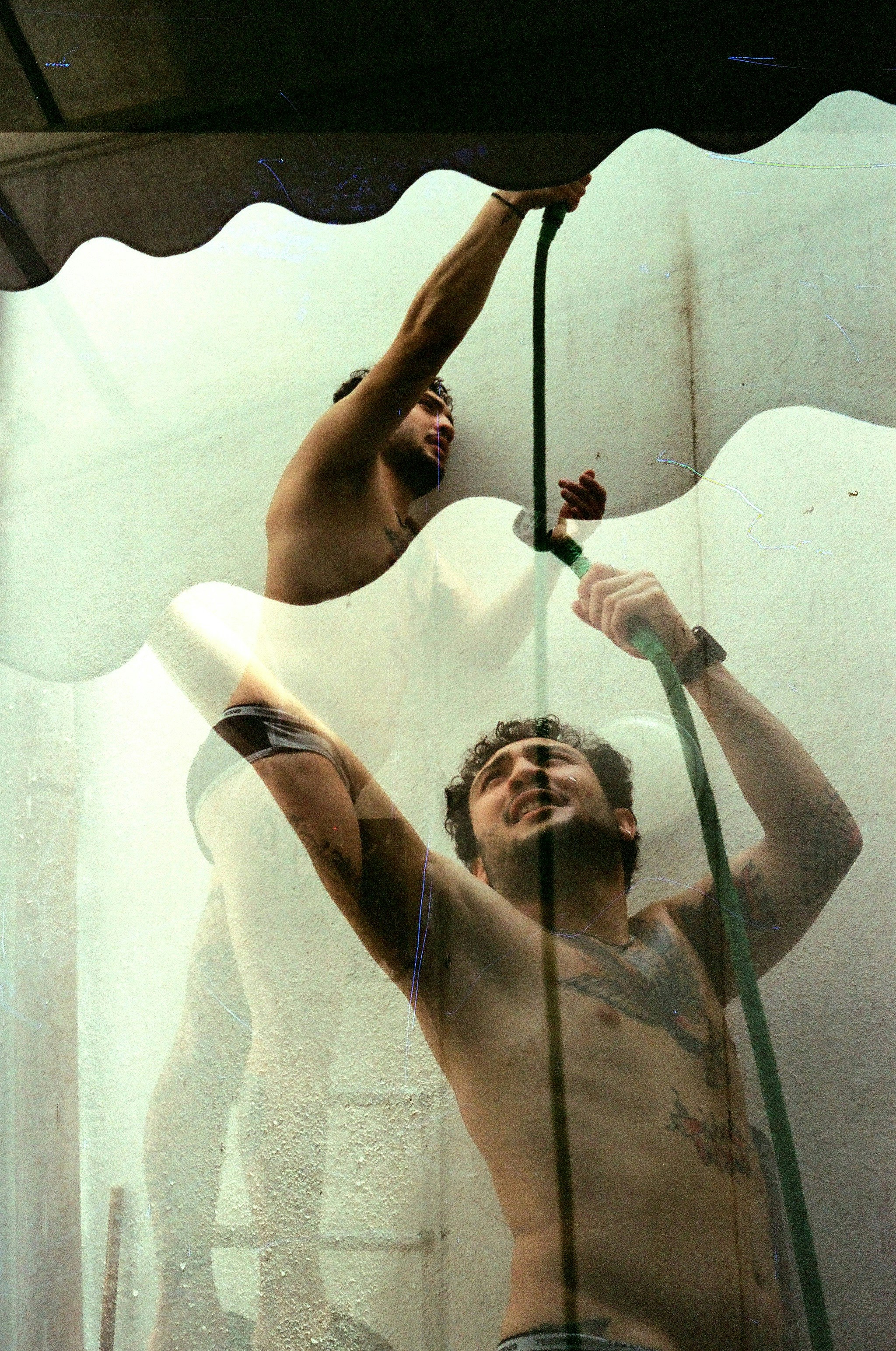 A couple of men standing in front of a shower