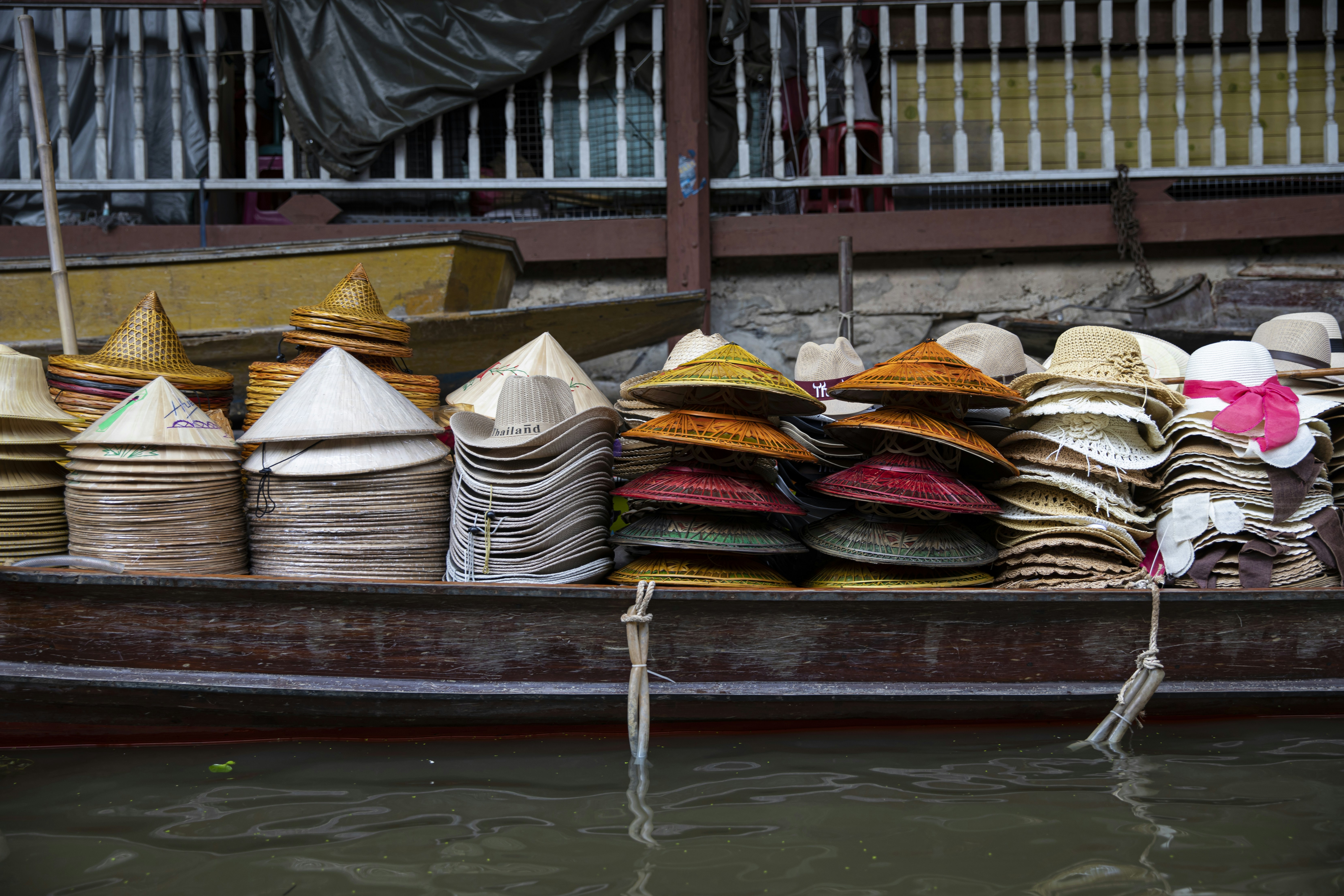 A boat filled with lots of different types of hats
