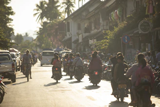 A group of people riding motorcycles down a street