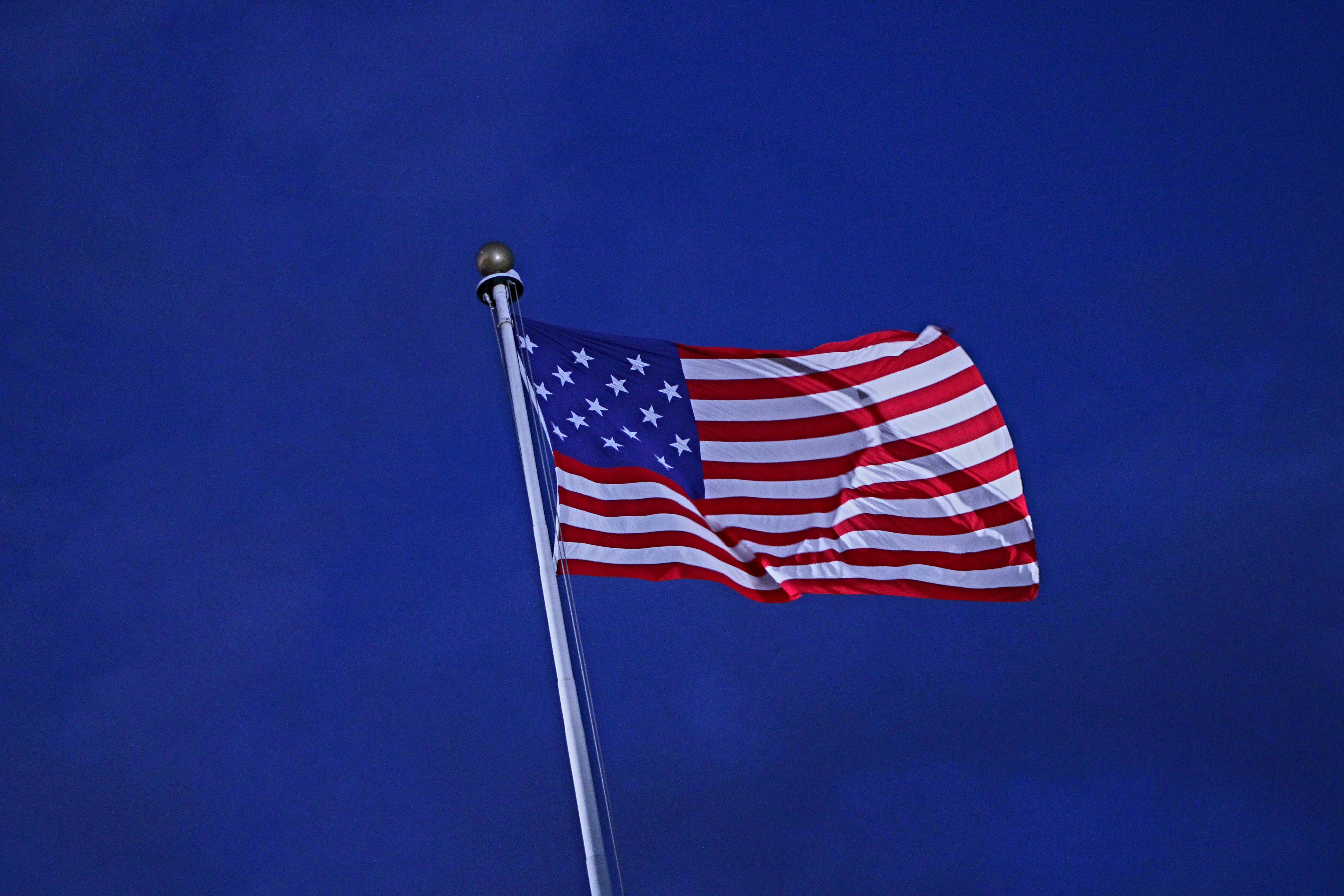 The american flag is flying high in the sky