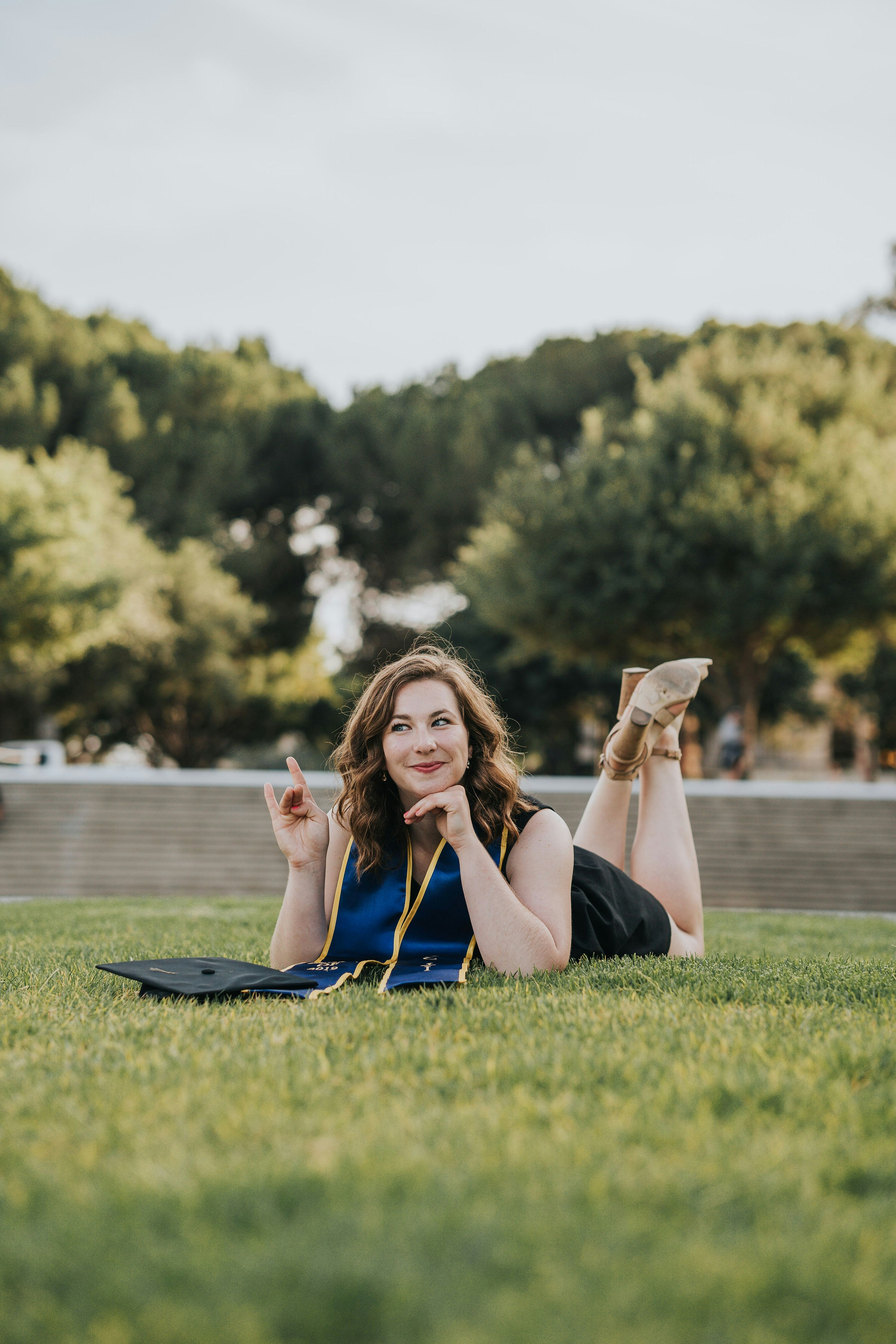 Eine Frau, die mit gekreuzten Beinen auf dem Gras liegt