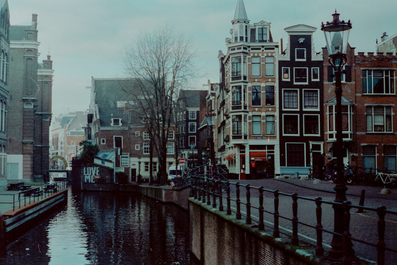 A canal running through a city next to tall buildings