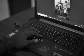 A person using a laptop computer on a desk