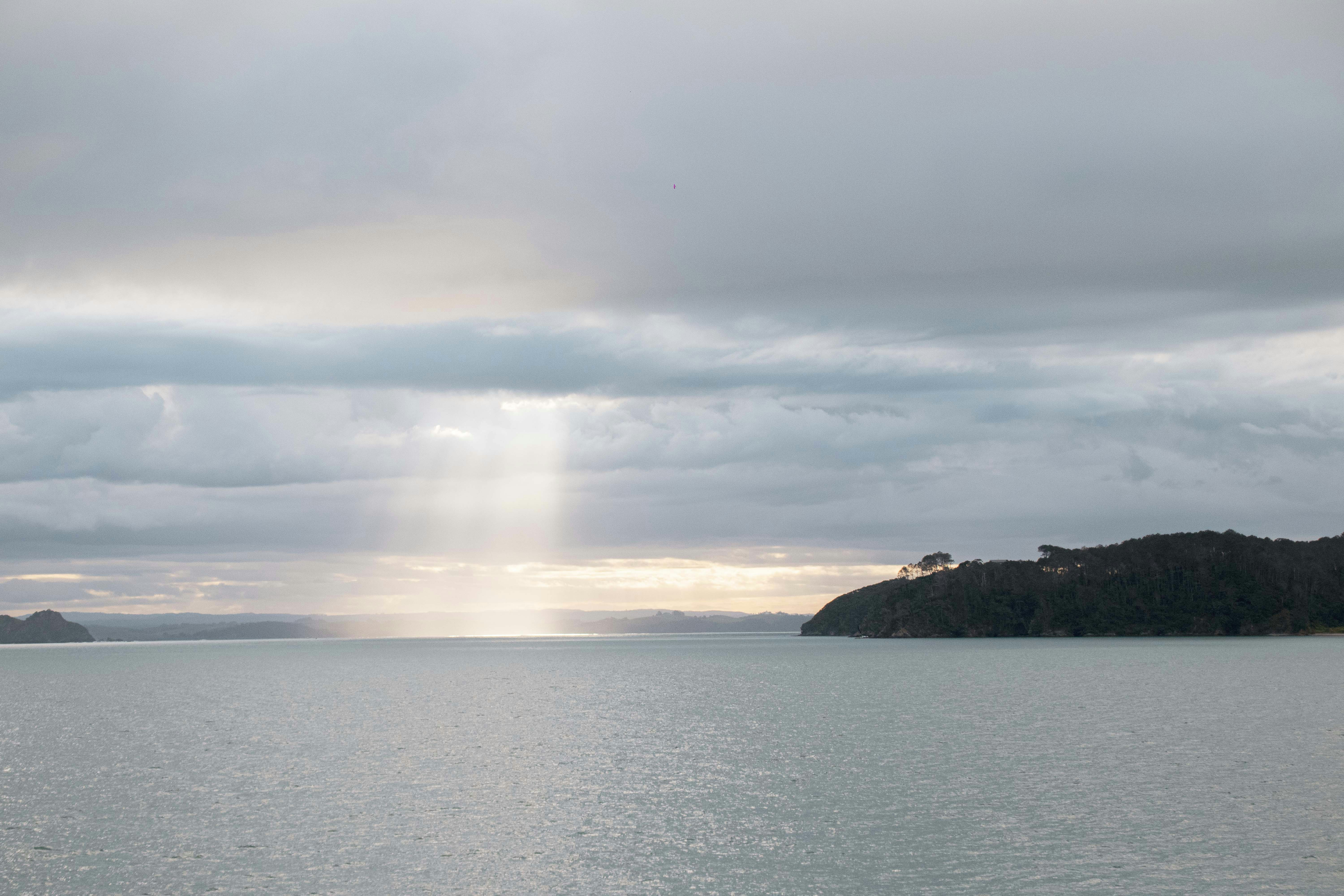 A large body of water under a cloudy sky