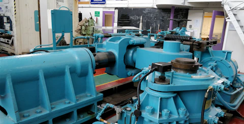 A large blue water power machine in a room