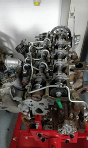 A large engine sitting on top of a red stand
