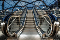 An escalator with a clock in the middle of it