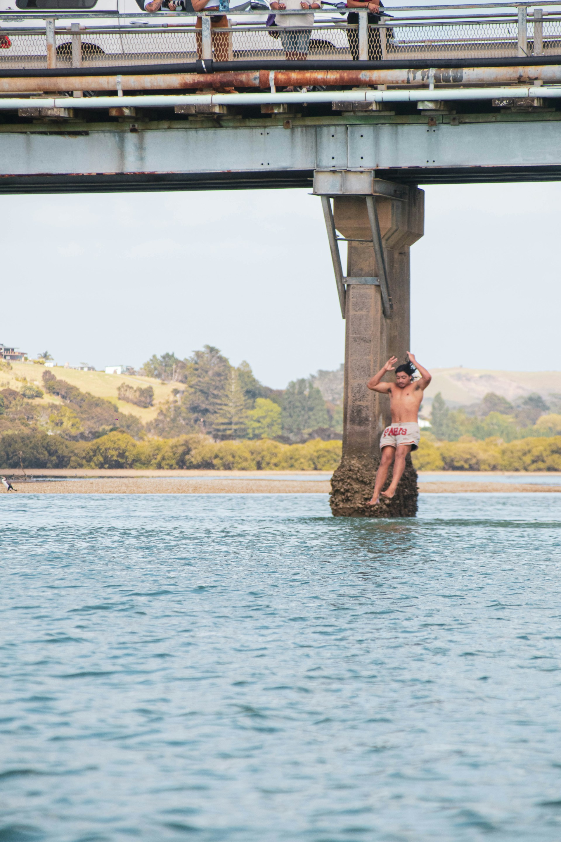 A group of people standing on top of a bridge